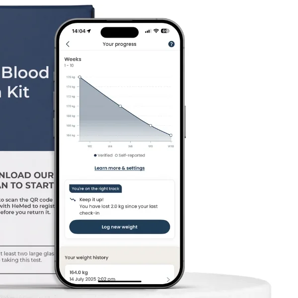 The HeMed app on a phone beside the blood collection kit